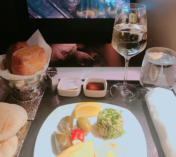 Meal and seatback screen in business class cabin