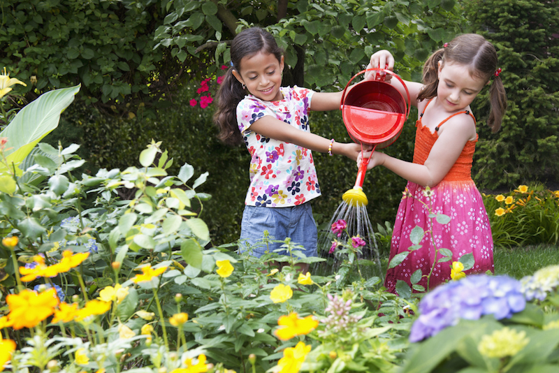 Girls watering garden