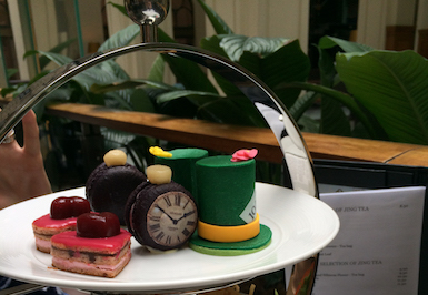 A plate of Alice in Wonderland-themed treats