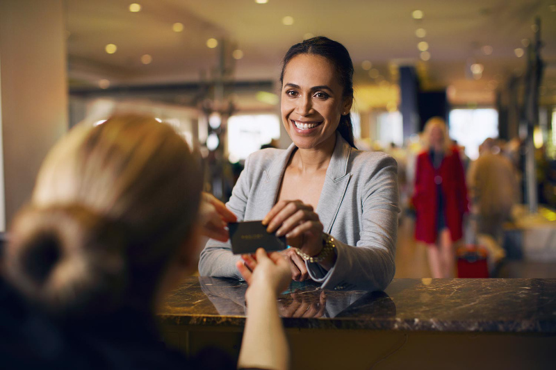A woman checking into a hotel