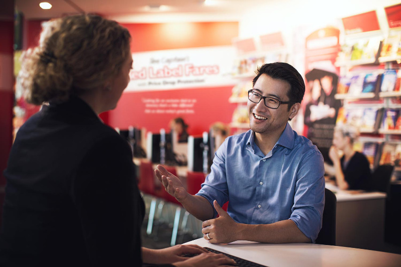 A man talking to an FCBT Travel Manager