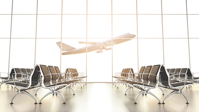 plane taking off seen through airport windows - frequent flyer points - flight centre business travel