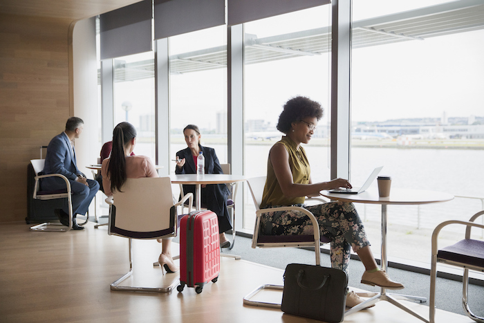 business travellers working in lounge - frequent flyer points - flight centre business travel