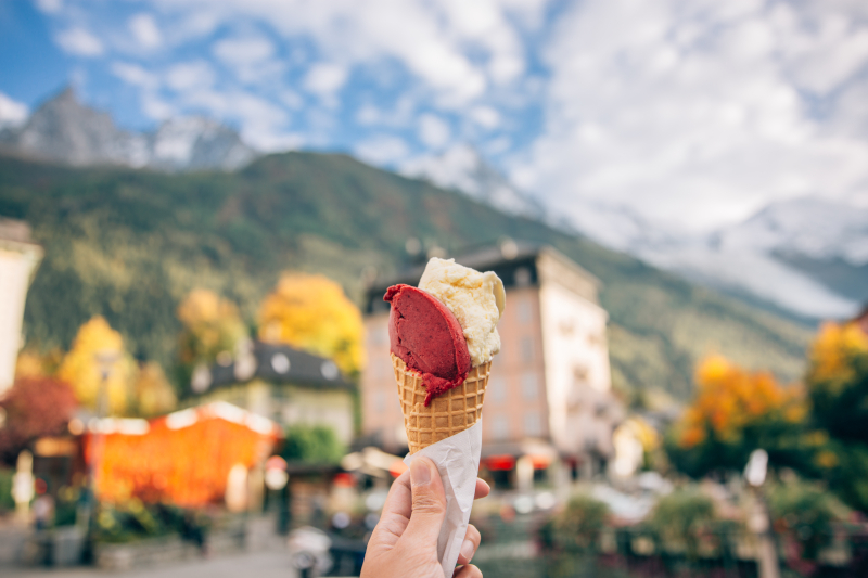 Hand holding a gelato. Background is blurred 