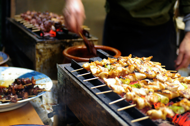 Yakitori stall showing chicken skewers being grilled 