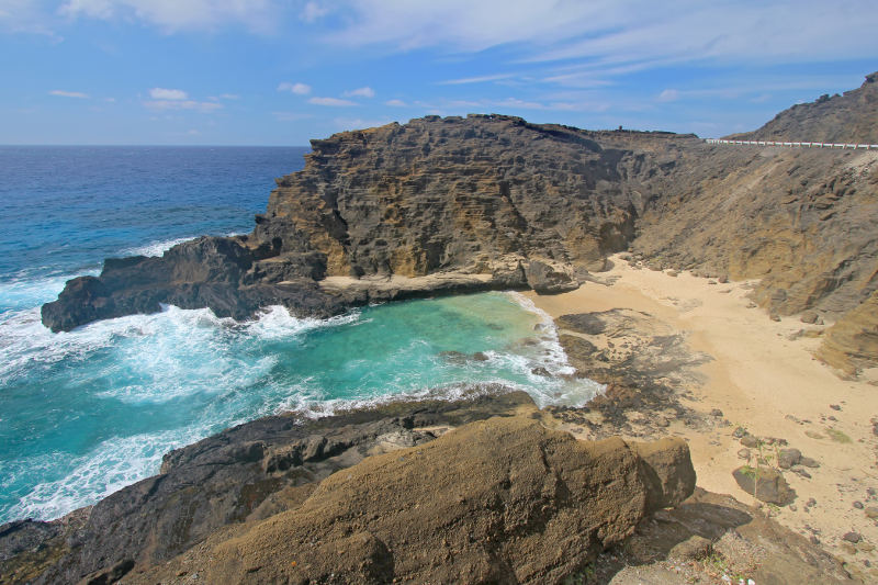 small beach between rocky outcrops