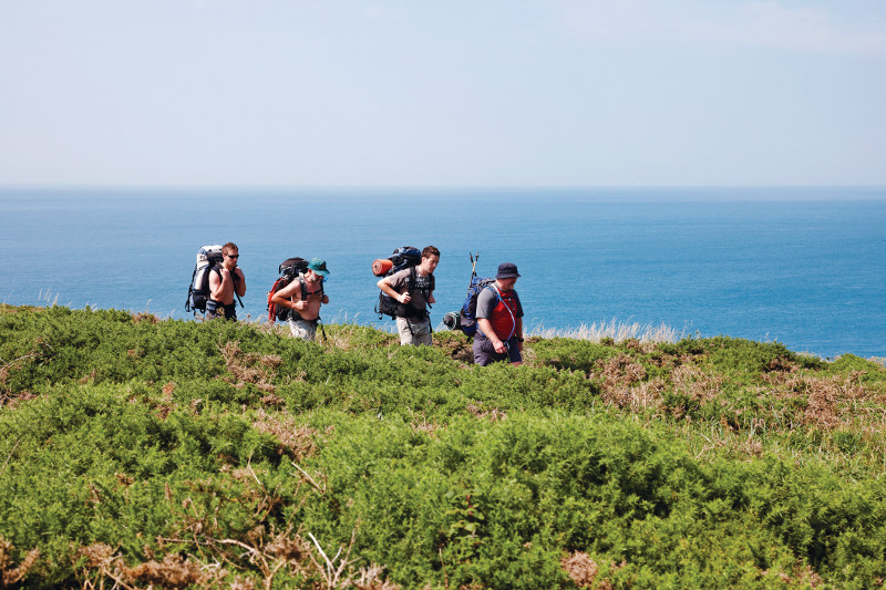 Walkers in the sun on the Pembrokeshire Coast Path.