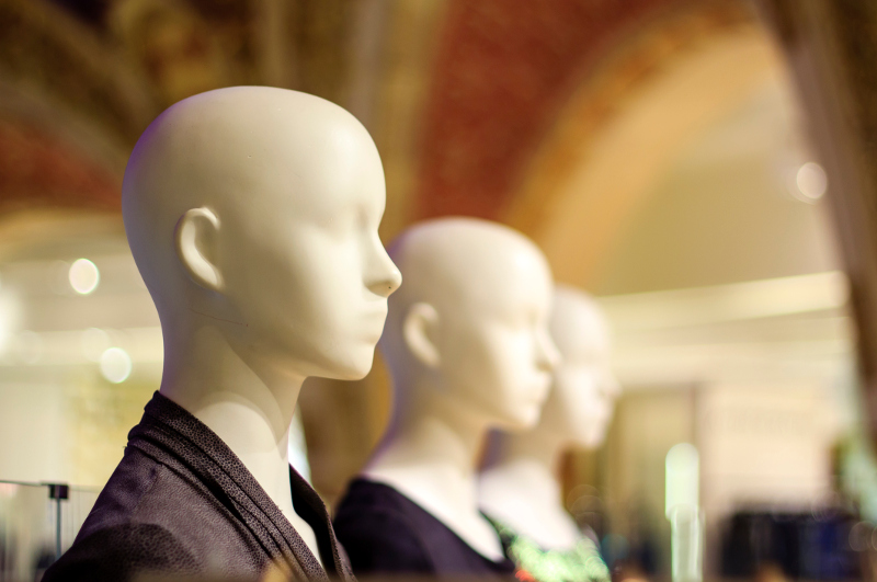 Mannequins inside a fashion store stare blankly ahead