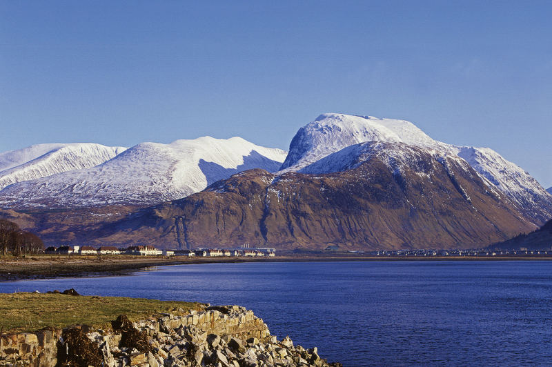 ben nevis covered in snow behind lake ben nevis covered in snow behind lake