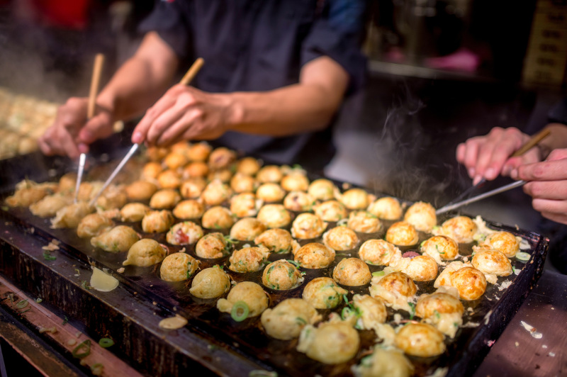 Takoyaki being cooked at a street stall