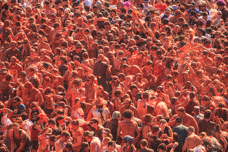 People throwing tomatoes at la tomatina festival in spain