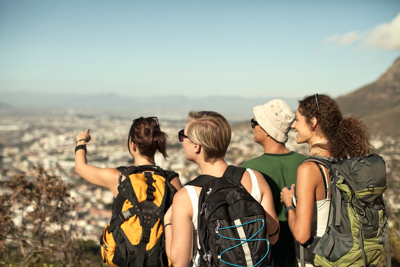 group on mountain overlooking city