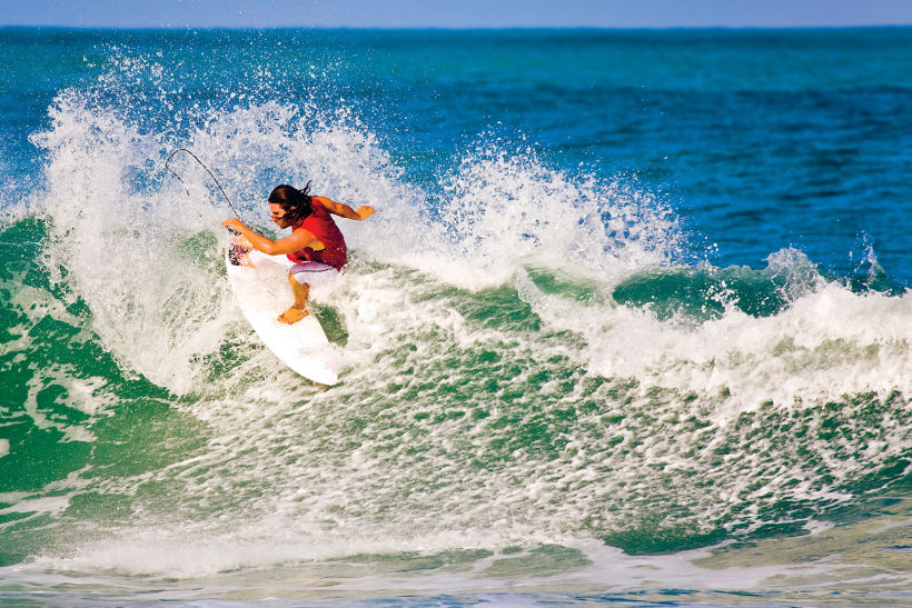 surfer riding wave in taiwan