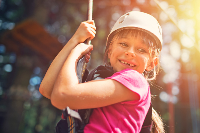 Young girl smiling on zip line