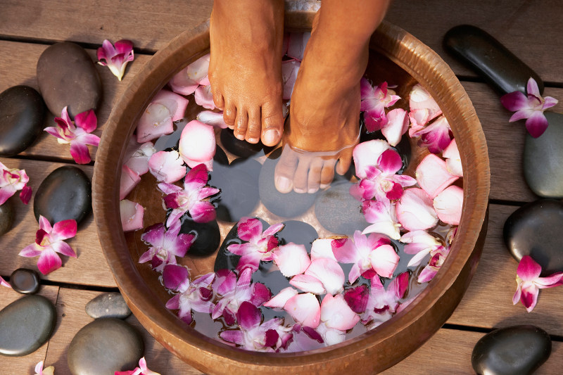 Feet in bowl with flower petals
