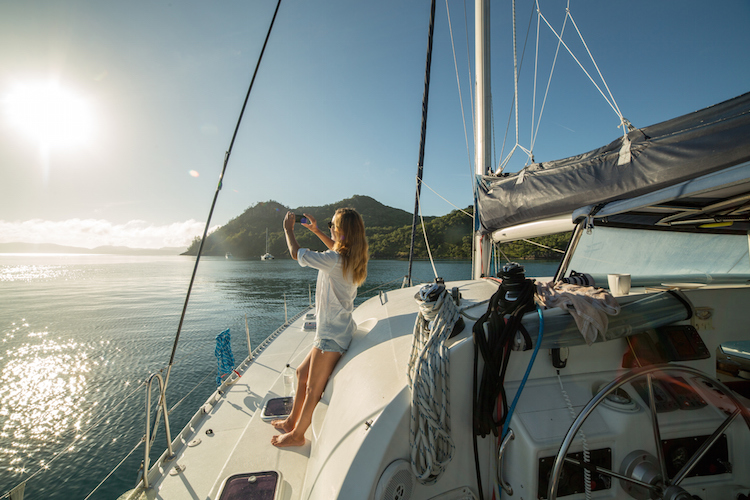 girl on yacht taking a photo