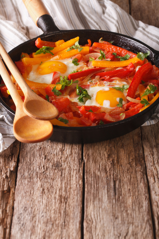 basque dish piperade with egg, capsicum in baking dish