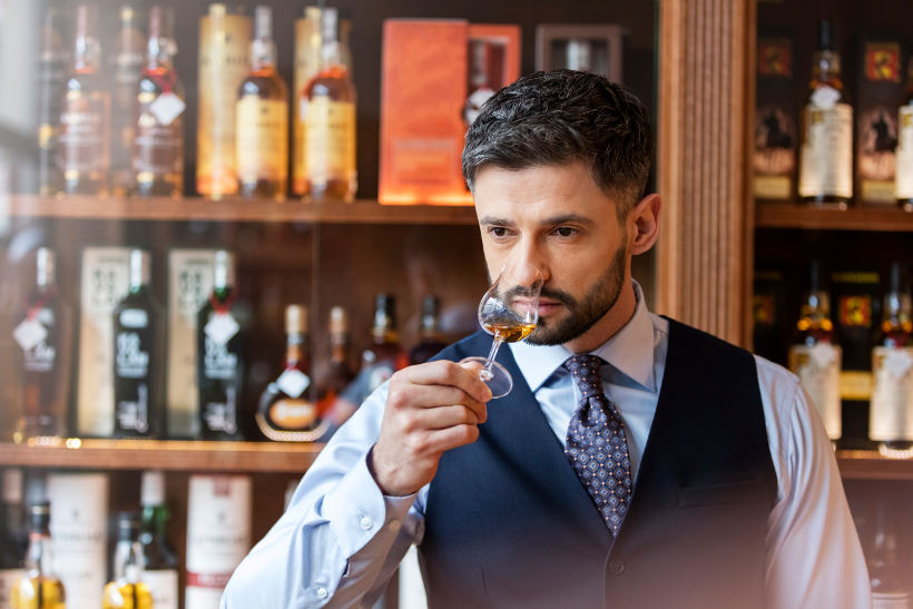 man smelling whisky