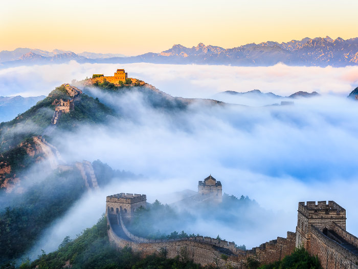 great wall of china at sunrise with fog