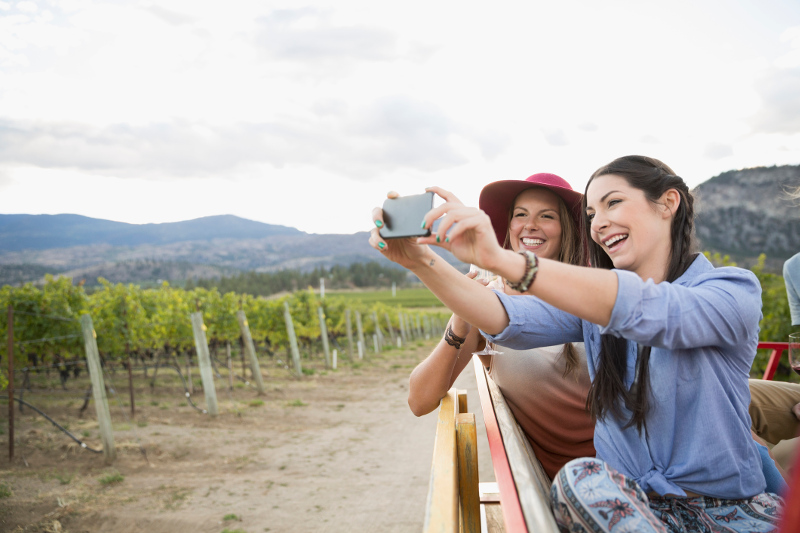 Two women take a selfie in a winery
