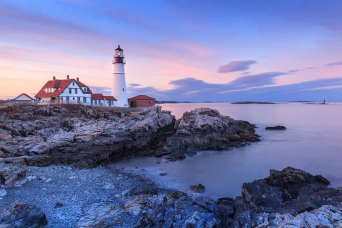 New england lighthouse and coastline at dusk