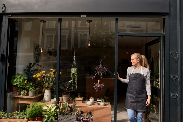 woman in doorway of plant shop london