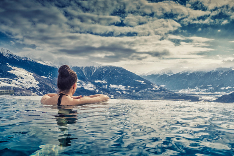 woman in pool overlooking mountains