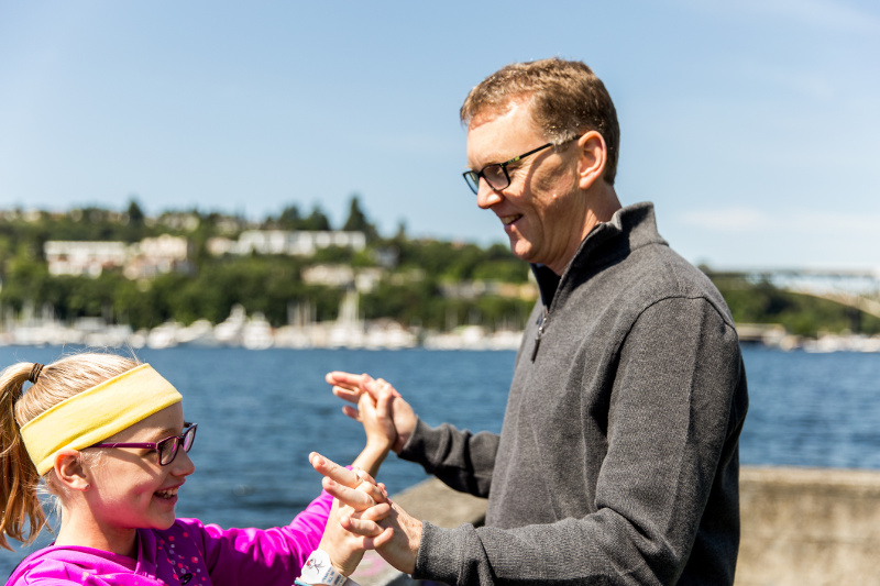 Father and daughter having fun at seaside