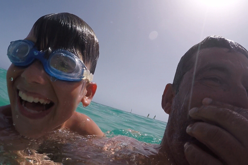 Father and son having fun in pool