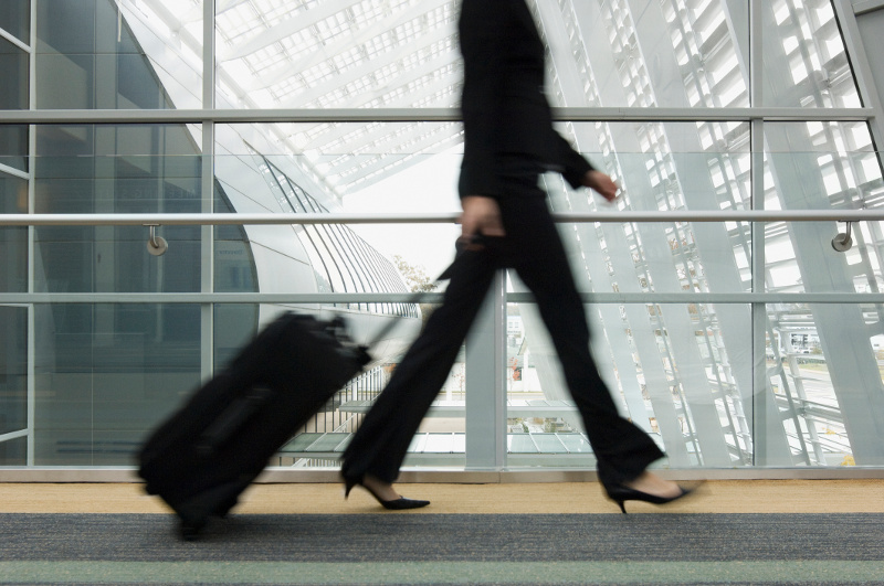 woman with hand luggage in airport