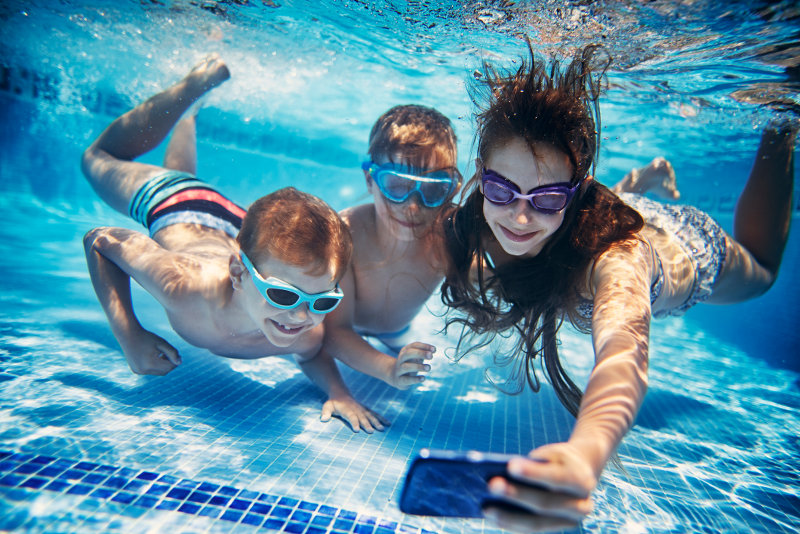 three kids taking underwater selfie