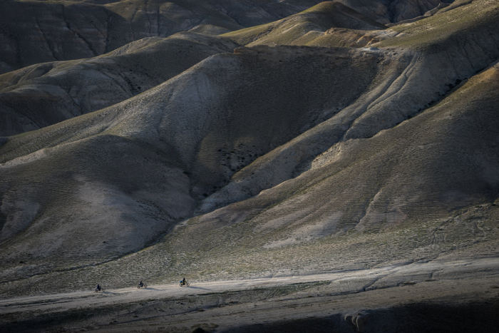 three motorbikes on road in nepalese mountains