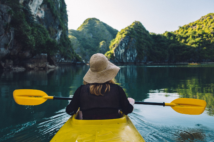 woman kayaking halong bay from behind