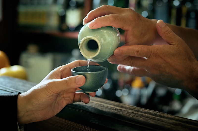 Sake (Japanese rice wine) is traditionally served warm, though more potent when consumed this way and is customary to be poured by another person.