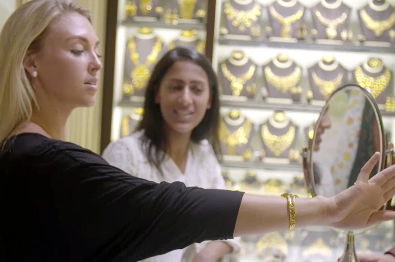 Greer tries on gold bangle in gold souk