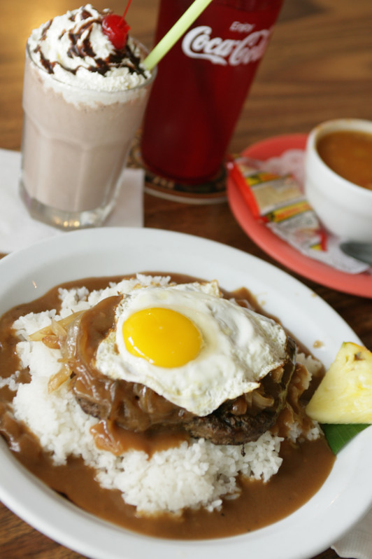 loco moco breakfast stack, eggs, rice, gravy and beef on a plate