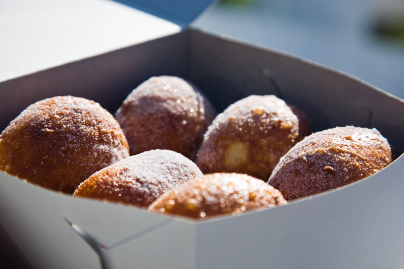 malasadas portuguese donuts in paper container