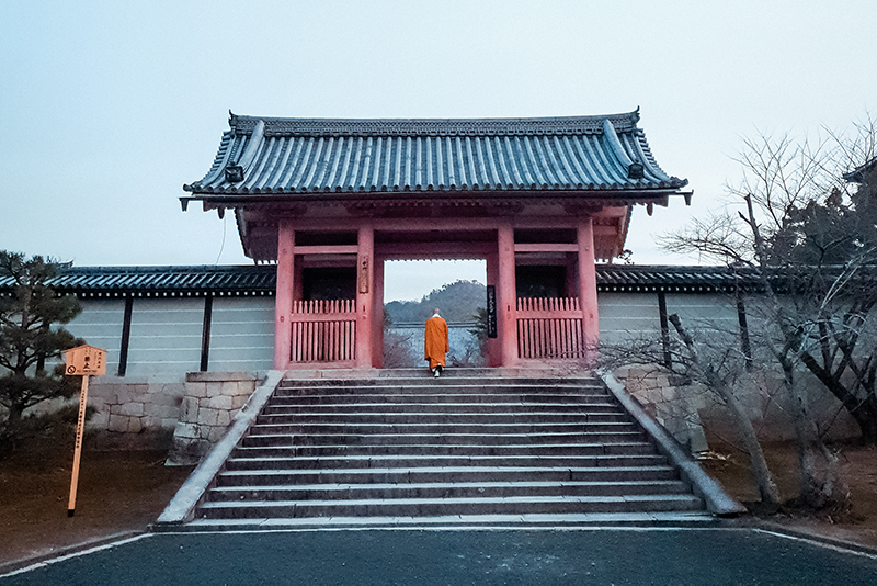 A monk climbs the steps to the inner gate of Ninna-Ji Temple in western Kyoto