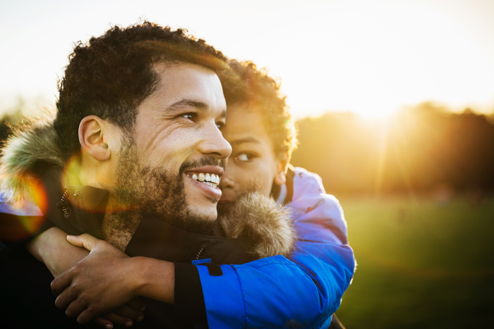 father and son with sun behind them - lessons from travelling with kids