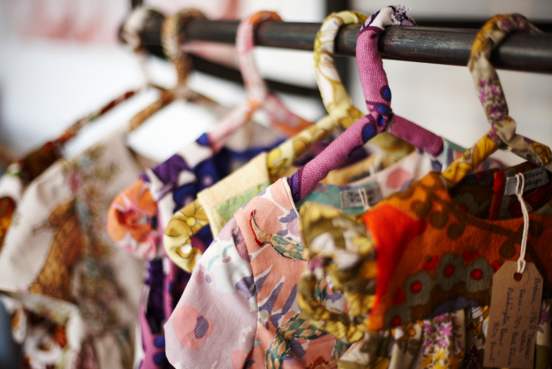 Fashion on clothes hangers at Spitalfields Market, London.