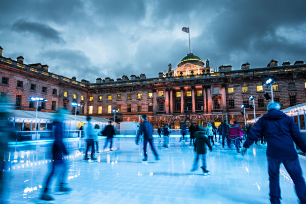 Ice skaters skating on an outdoor rink