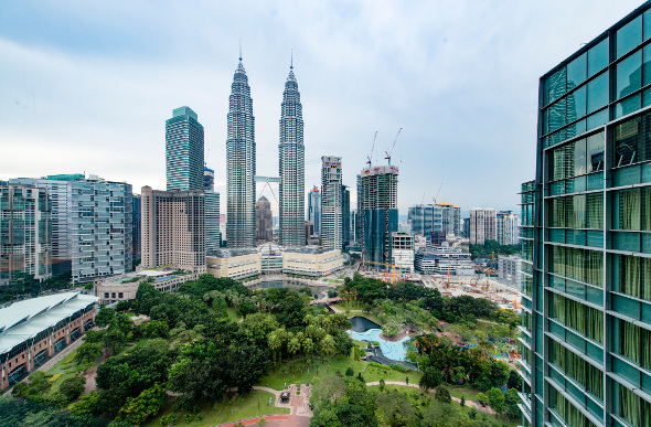 The Petronas Towers dominate the skyline of Kuala Lumpur, Malaysia.