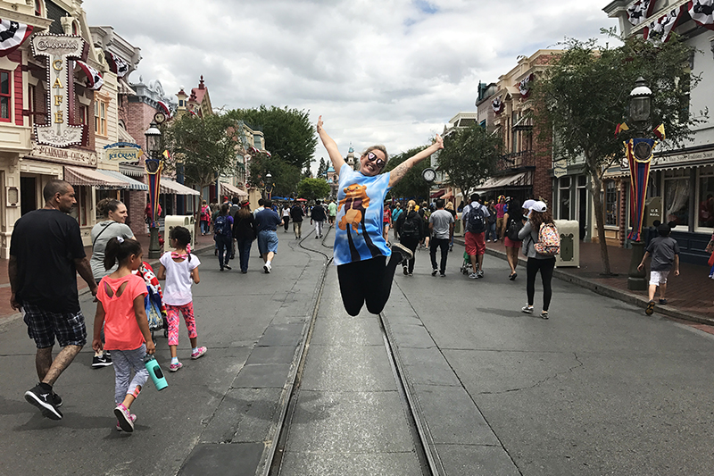 marnie jumping into the air at main street usa disneyland