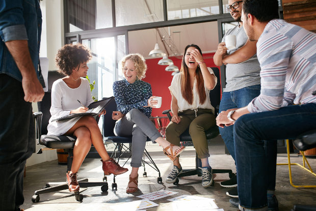 A group of young office workers enjoy a chat.