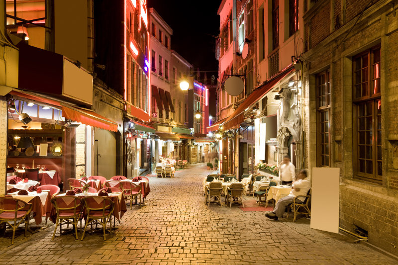 Restaurants line a cobbled alley in the Belgian city of Brussels.