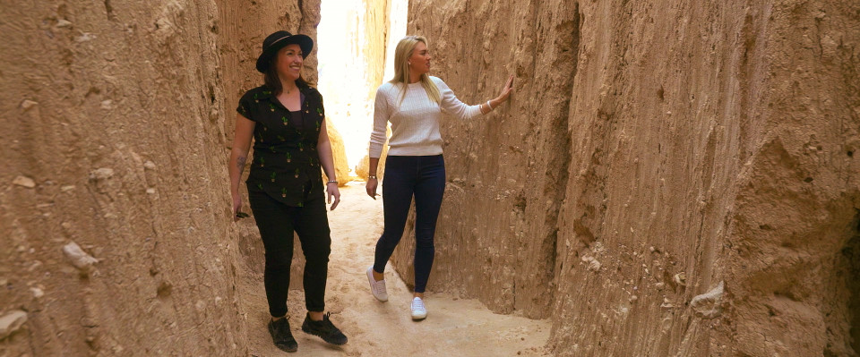 greer and kelly walking through rock formation nevada