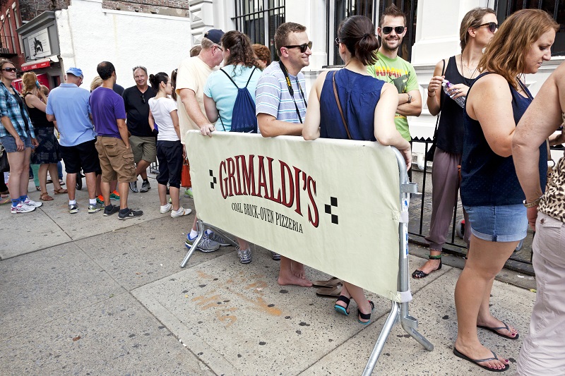People lining up outside the famous Grimaldi's pizzeria in Brooklyn. Image: Getty