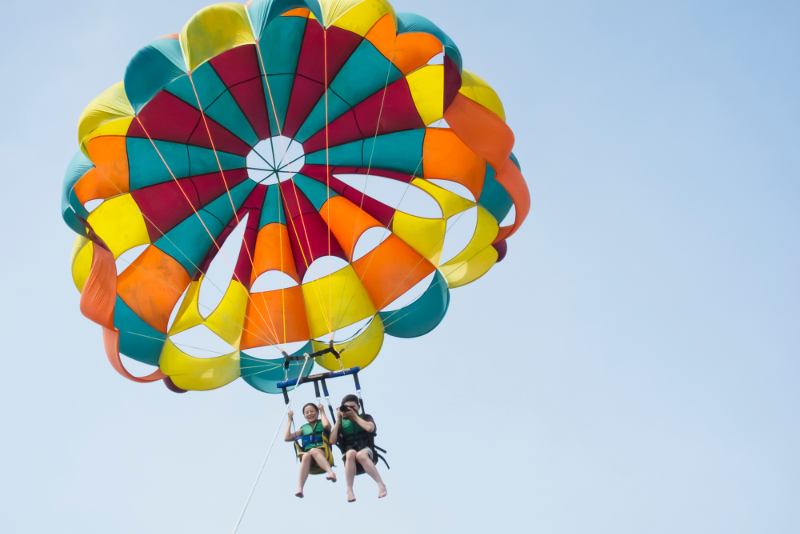 A pair of people in a parasail