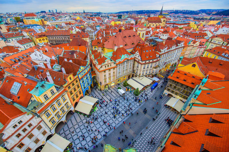 Tourists explore Prague's bustling Old Town Square.