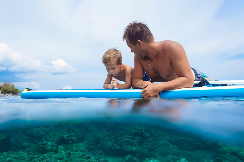 Father and son on a surfboard